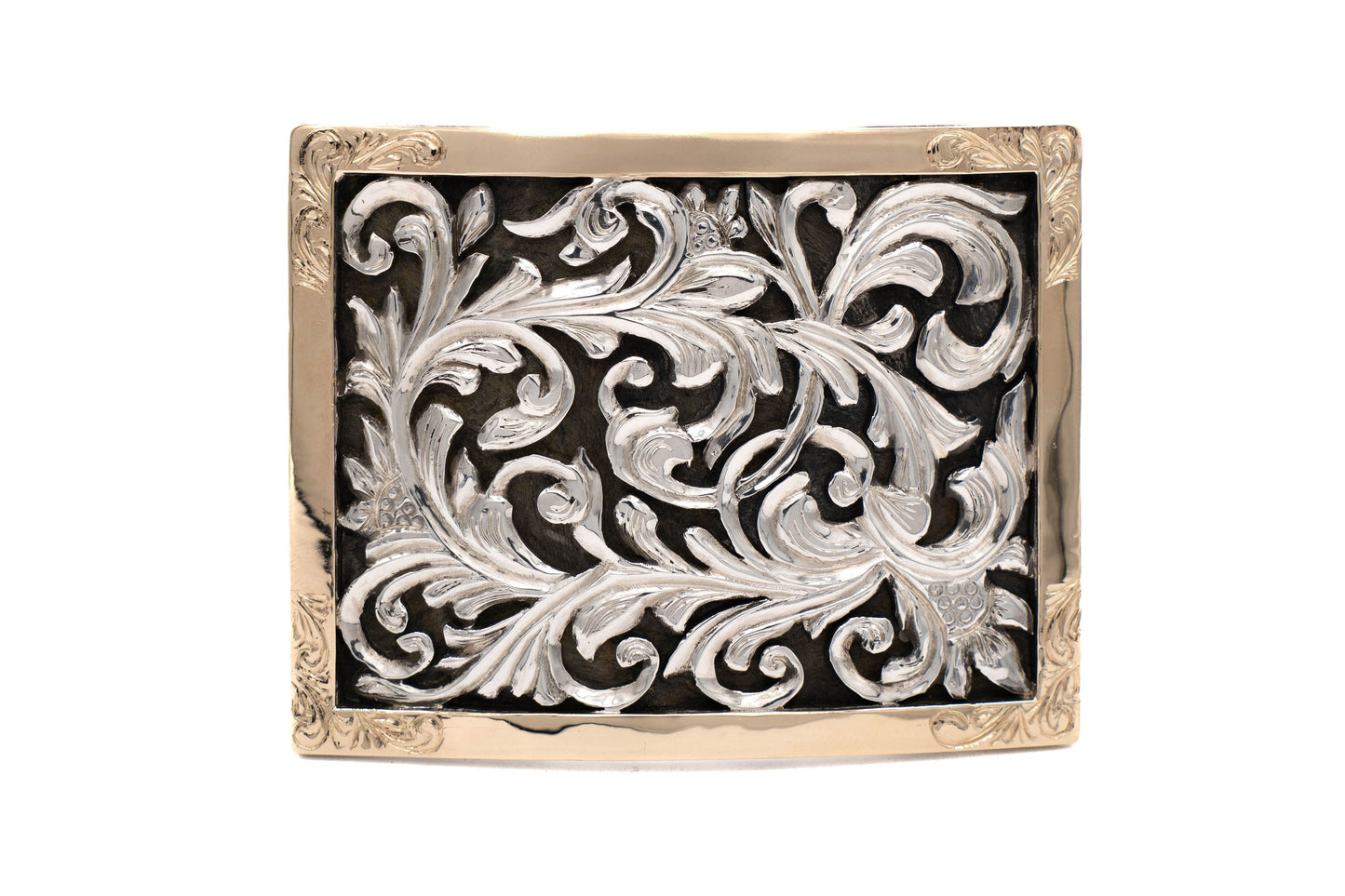 Decorative belt buckle with intricate silver design, 14kt gold bezel on a black background