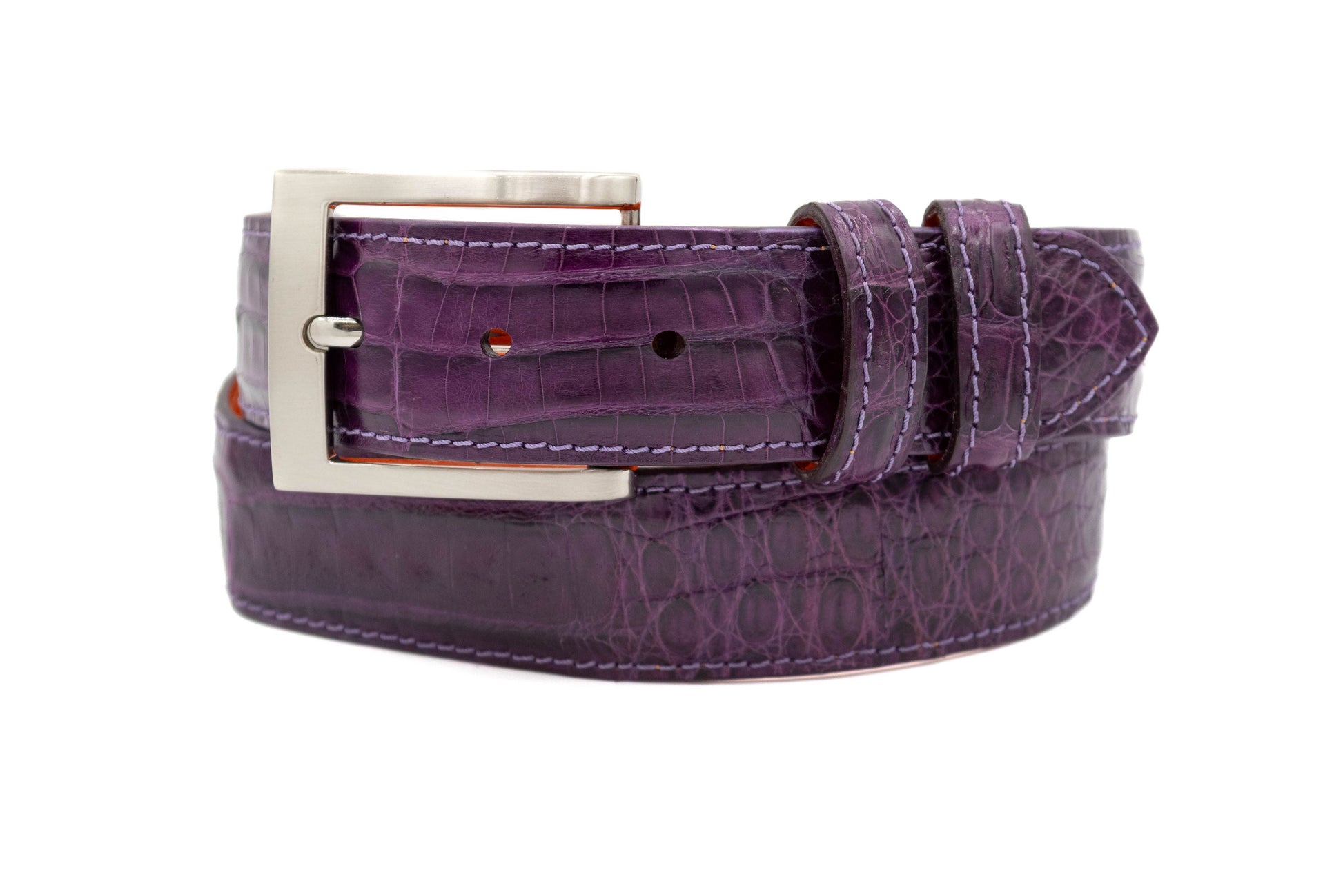 Purple crocodile belt with a silver buckle on a white background