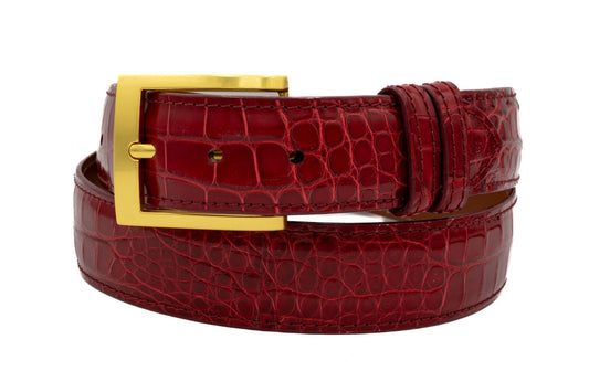 Red Alligator leather belt with a gold buckle on a white background
