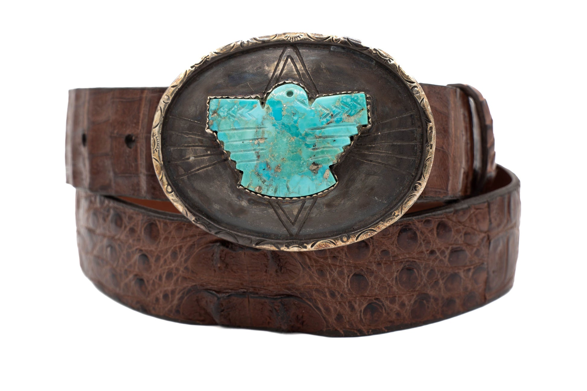 Brown belt with a turquoise Thunderbird and silver buckle on a white background